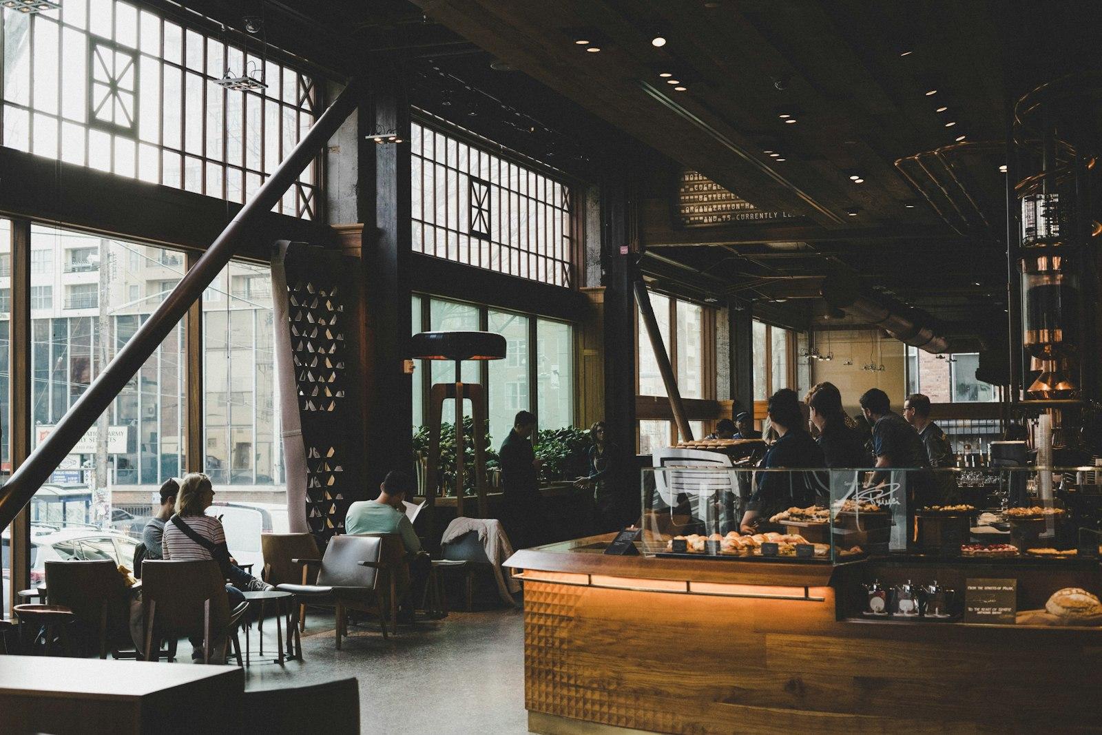 Warmly lit café with people relaxing at tables