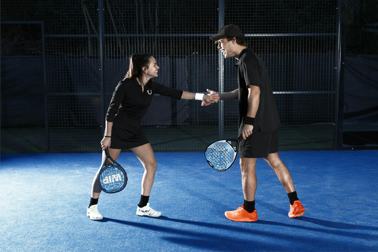 Two padel players shaking hands after a match